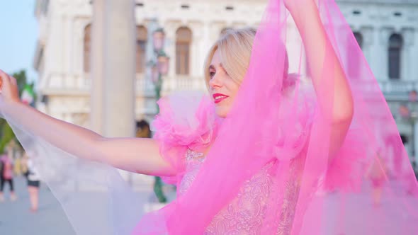 Young Blonde Girl Posing in Pink Elegant Dress