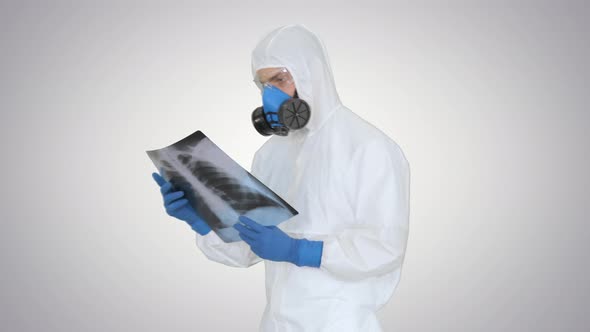 Medical Doctor in Protective Suit Walking in with X-ray Picture on Gradient Background