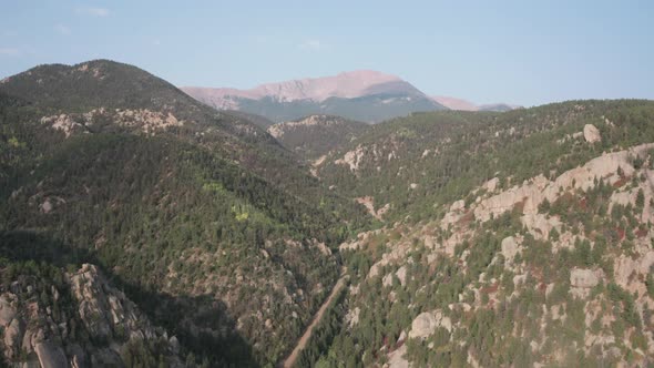 Slow aerial descent over mountains, Pikes Peak granite in background