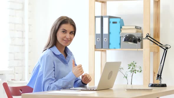 Thumbs Up Gesture by Woman at Her Work