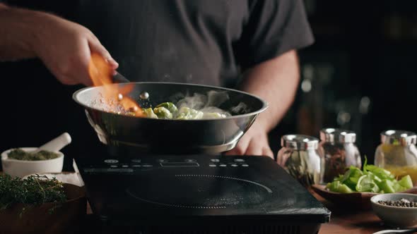 Chef Frying Green Brussels Sprouts Cabbage in Pan Closeup