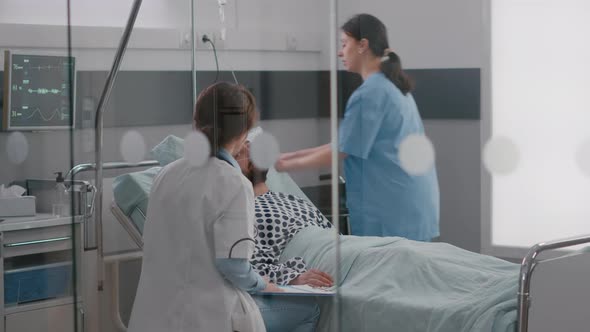 Practitioner Specialist Doctor Writing Sickness Treatment on Clipboard