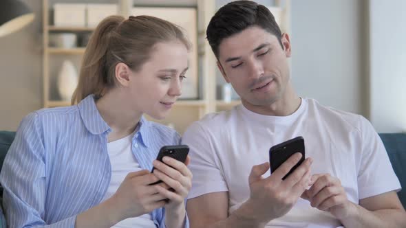 Man and Woman Sharing Information on Smartphone