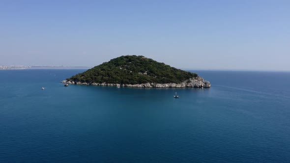 Aerial Seascape with View of Green Island and Sailing Boats in Turquoise Water