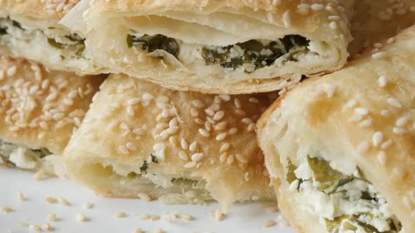 Tasty stuffed  filo pie with sesame cheese and spinach served on plate 4K 2160p 30fps UHD footage - 