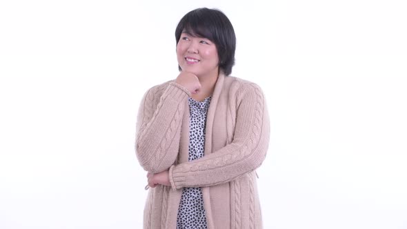 Happy Overweight Asian Woman Thinking Ready for Winter