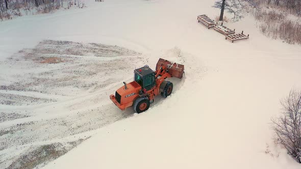 Piling up snow with a front end loader