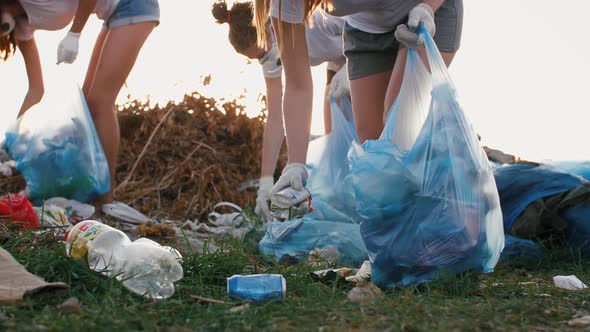 Close Up Shot of Group of Eco Volunteers Cleaning Up Area of Dump Near the Field