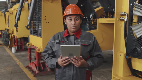 Black Woman Posing at Factory