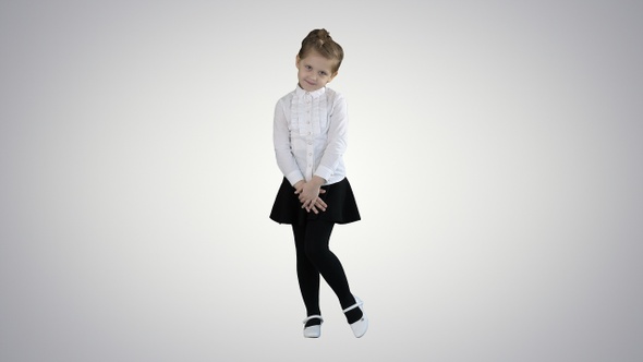 Little girl posing in different poses on gradient background.