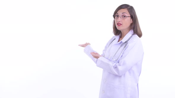 Stressed Woman Doctor Talking While Showing To the Back