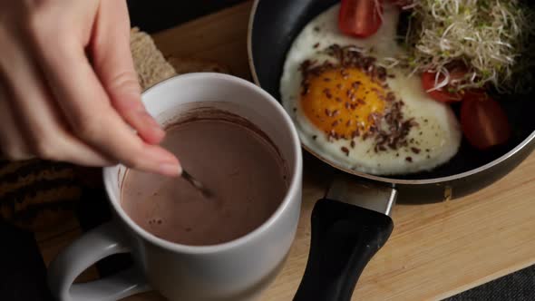 Closeup of Woman Having Breakfast of Hot Chocolate and Scrambled Egg