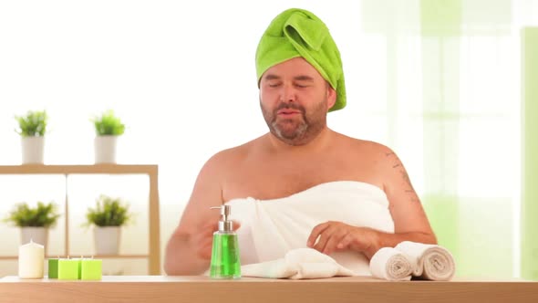 Overweight Man Applies Beauty Treatment at Health Spa