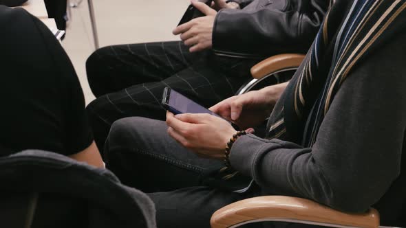 Closeup of Hands Holding Mobile Phone and Typing Sms