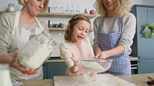 Video of little girl helps to sift the flour. Shot with RED helium camera in 8K.