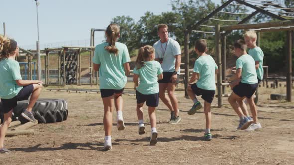 Group of Caucasian children training at boot camp