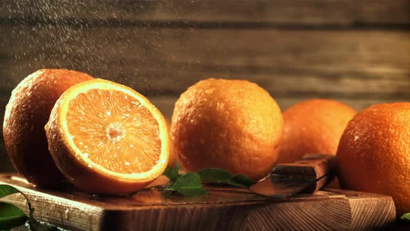 Drops of Water Fall on Fresh Oranges