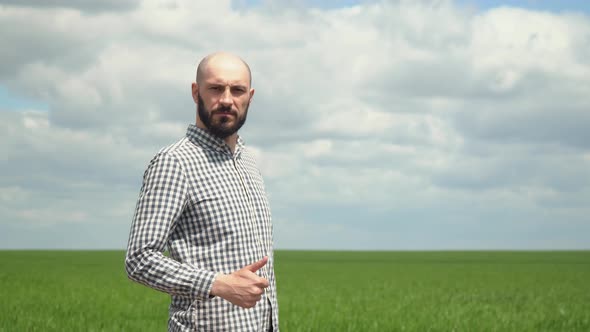 Portrait of Farmer Man with Beard Looking to Camera in Wheat Field