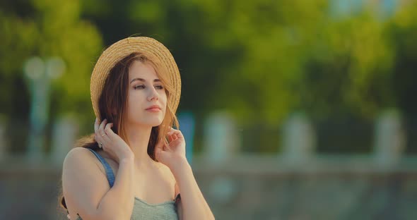 Pretty Young Woman Walks Along the Beach Smiling Thoughtfully