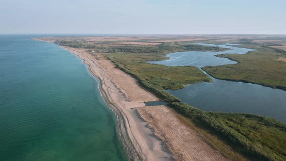 Aerial fly over beautiful empty endless wild beach