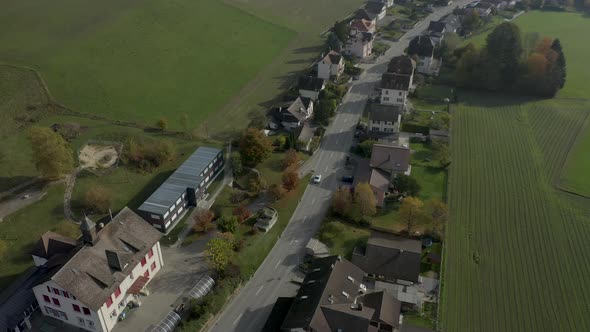 Aerial view of a car driving through a village. DJI Mavic