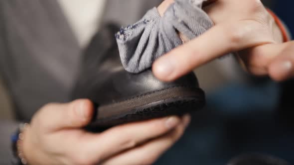 Male Cobbler Explains How To Polish Shoes Using Cloth