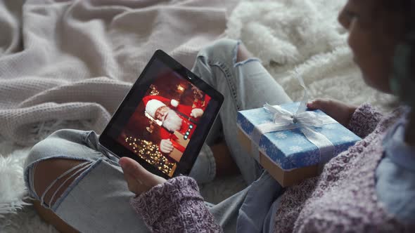 Happy African Kid Girl Talking To Virtual Santa on Video Conference Call