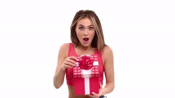 Portrait of Amazed Woman Opening Festive Gift Box Rejoicing Holiday Isolated