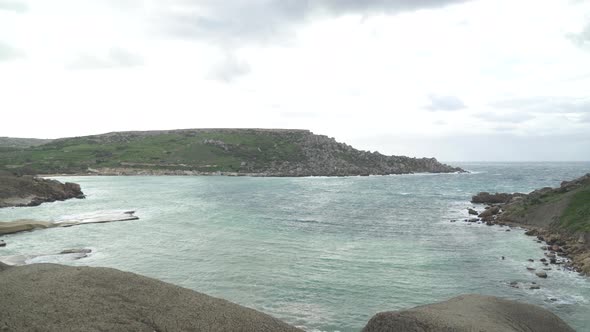 Walking Towards Qarraba Bay on Very Windy Day with Grey Rain Clouds Forming in Sky