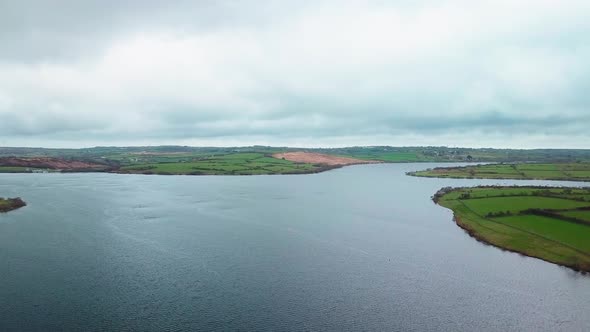 Beautiful calm Stithians Lake under a cloudy sky in the UK - aerial