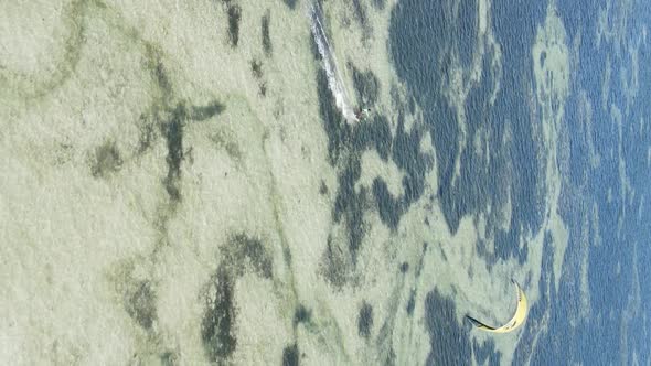 Vertical Video Kitesurfing Near the Shore of Zanzibar Tanzania Aerial View