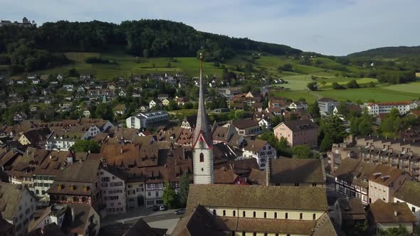Aerial orbit of St. George Monastery and tower in charming Stein am Rhein town near Rhine river, hil