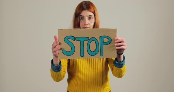 Ukrainian Girl Holding an Antiwar Placard in Her Hand