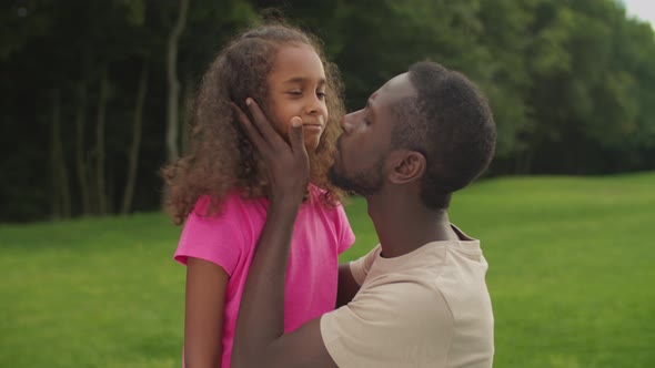 Loving Father Comforting Sad Daughter Outdoors