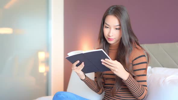Young asian woman read book