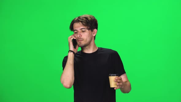 Brunette Man Walking Talking on the Phone and Drinking Coffee, Chroma Key