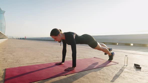 Female Athlete Doing Side Plank in Morning