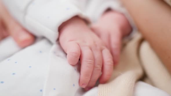 Closeup Shot of Lttle Hands of Sleeping Newborn Baby Boy