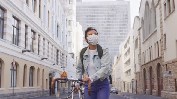 Woman wearing medical coronavirus mask walking on the street