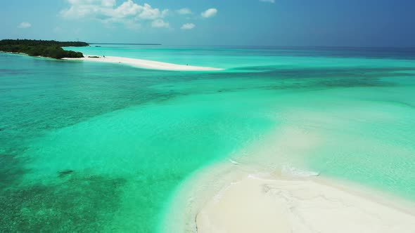 Wide aerial copy space shot of a white sandy paradise beach and aqua blue water background 