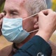 Senior Caucasian Woman Helps Puts a Medical Mask on the Face of an Senior Man - VideoHive Item for Sale