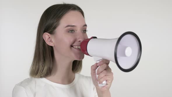 Announcing Young Woman Shouting Through a Megaphone, White Background