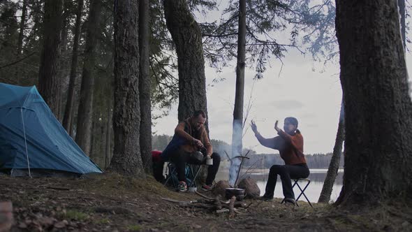 A Beautiful Cinematic Shot of Two Young Tourists a Man and a Woman in Wood