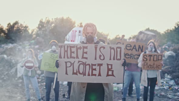 Portrait of Young Man and Woman Activist With a Poster Calling for the Care of the Environment