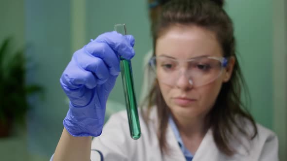 Chemist Researcher Woman Holding Test Tube with Dna Liquid