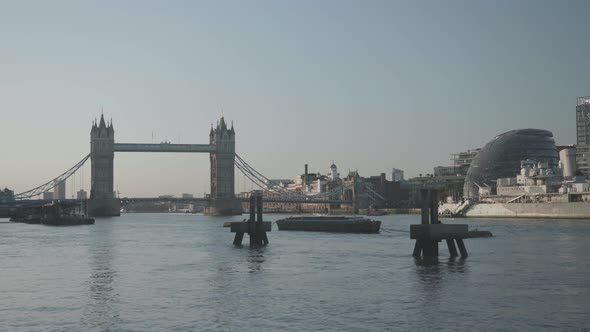 Wide angle shot of the Tower Bridge in London at a summer morning in 2020. City Hall and the HMS Bel