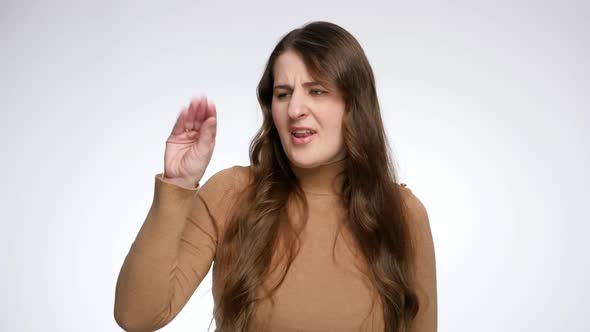 Sceptical Young Woman Making Blah Gesture with Hand