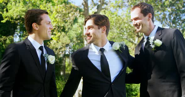 Three men are happy at wedding hugging each other 4K 4k
