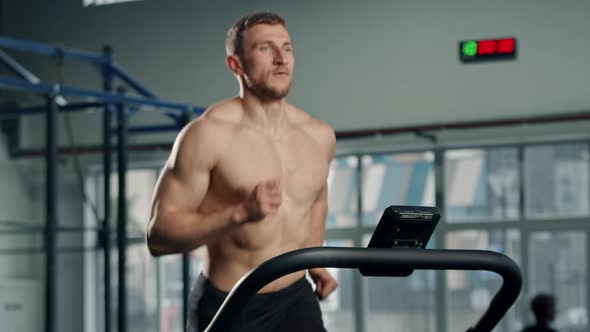 Male athlete athlete is doing cardio training on a treadmill, bodybuilder is running