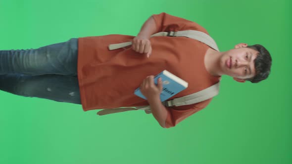 The Front View Of Asian Boy Student Holding A Book And Running To School On Green Screen